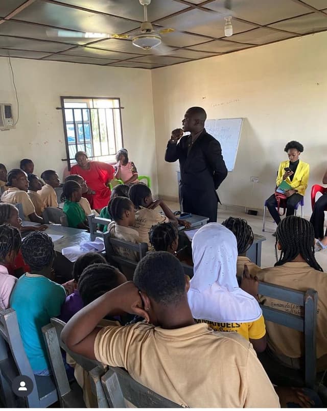 a man addressing children in the classroom